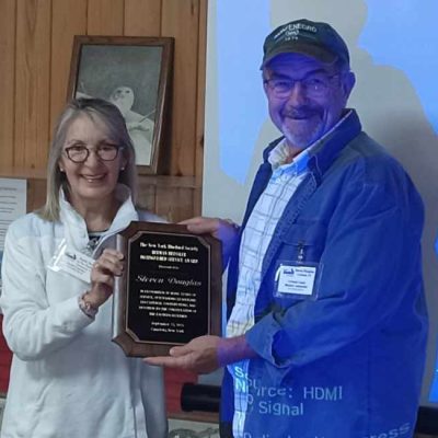 Steven Douglas receiving the 2023 Herman Bressler award from  Martha Moran