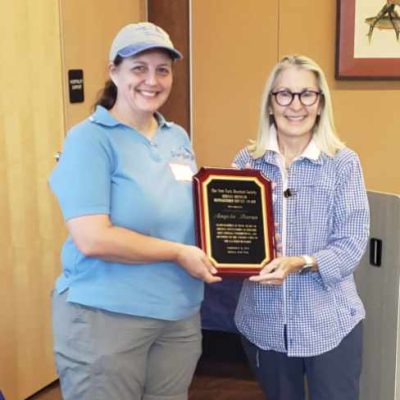 Angela Baron receiving the 2024 Herman Bressler award from Martha Moran