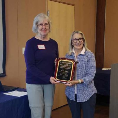 Judy Thurber receiving the 2024 Fran Hanes award form Martha Moran